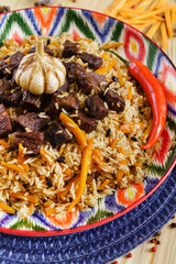 Pilaf with mutton, carrots, onions, garlic, pepper and cumin. A traditional dish of Asian cuisine.