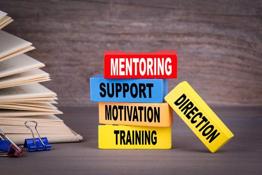 Mentoring concept. Colored wooden blocks on the table.