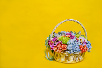 Fototapeta na wymiar flower basket on yellow background