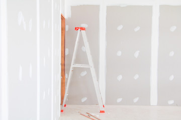 stair and gypsum board wall interior decoration of home at construction site with copy space add text