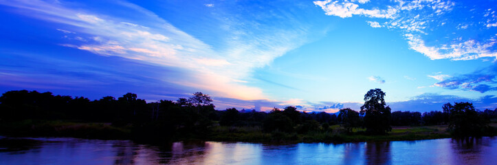 panorama sunset in sky reflex river beautiful colorful landscape silhouette tree woodland twilight time with copy space add text