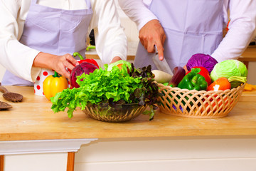 People is preparing for making salad with lots of vegetable