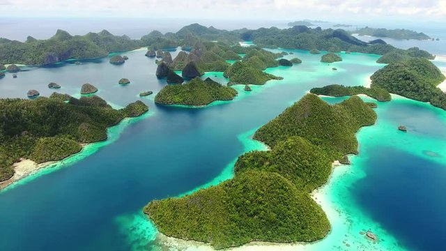 Amazing Green Field Island Floating in the Air Isolated with Blue Background. Beautiful Aerial View of Paradise Tropical Islands. Top View. Sea Surface Aerial View. From Above. Beach Sand Background