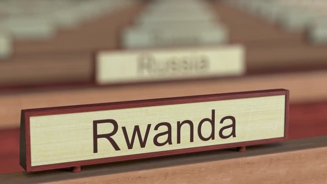 Rwanda name sign among different countries plaques at international organization. 3D rendering