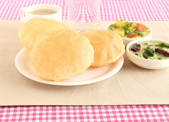 Poori, also known as Indian fried bread, is a traditional and popular Indian vegetarian food, usually made for breakfast or lunch, with potato curry and coconut chutney as side dishes.