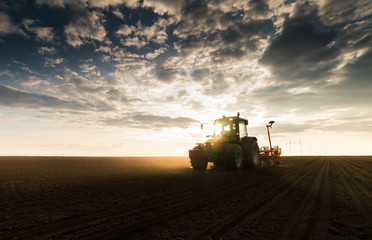 Farmer with tractor seeding - sowing crops at agricultural field in spring © Dusan Kostic