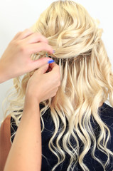 Hairdresser's hands make hair extension