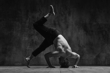 Young beautiful dancer is posing in studio