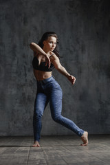 Fototapeta na wymiar Young beautiful dancer is posing in studio