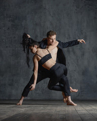 Fototapeta na wymiar Couple of ballet dancers posing in studio