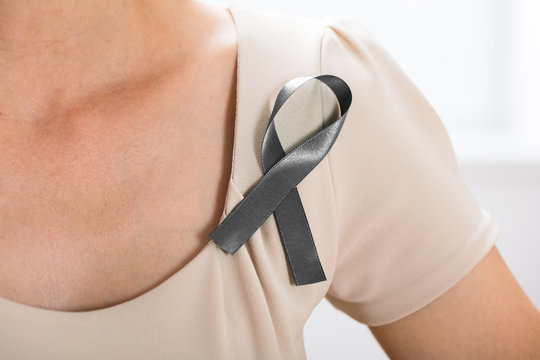 Woman With Grey Ribbon To Support Breast Cancer Cause