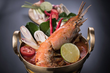 Spicy soup with shrimp in bowl , famous Thai food cuisine calling Tom Yum Kung