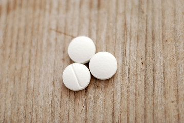 Pills on wood background,top view