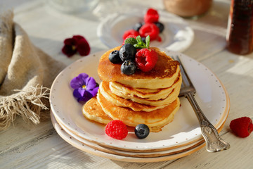 Golden pancakes with berry and honey