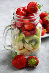 Fruits salad in glass jar to go