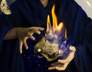 flammable paper wad in hands of magician