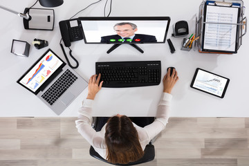 Elevated View Of A Businesswoman Videoconferencing On Computer