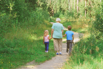 grandmother with kids walk in nature