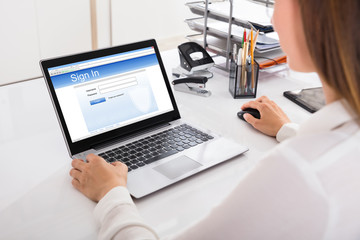 Businesswoman Signing Into A Website On Computer