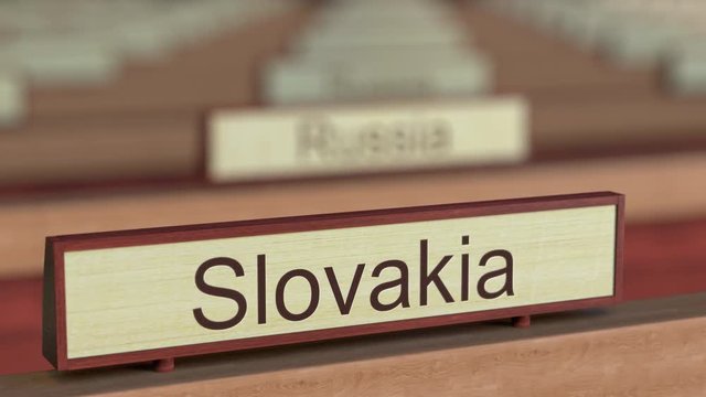 Slovakia name sign among different countries plaques at international organization. 3D rendering
