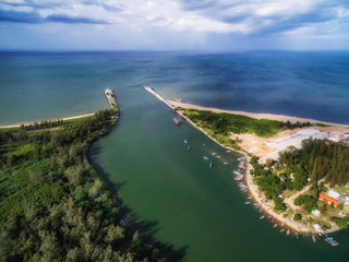 Estuary in Pranburi with breakwater and boats in fishing village