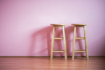 chairs on pink wall