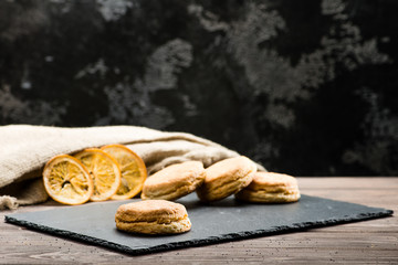 classical Italian fresh delicious homemade raisin scones on table, dark background