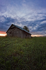 Sunset Clouds And An Old Barn House