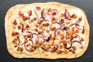 homemade delicious pie with meat and onion on dark background, top view