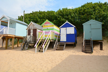 Brightly painted wooden beach huts at Wells-next-the-sea in Norfolk England