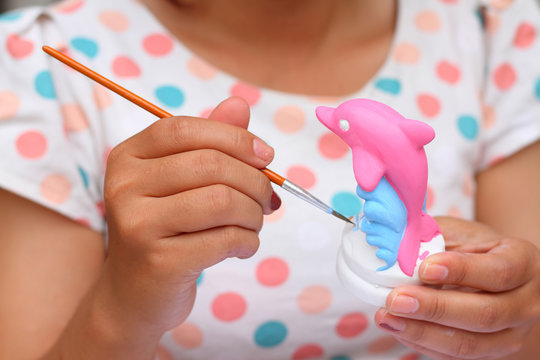 close up women hand art kid paint watercolor dolphin plaster for education background - Powered by Adobe