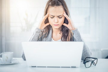 Young woman is tired and feels stressed out.