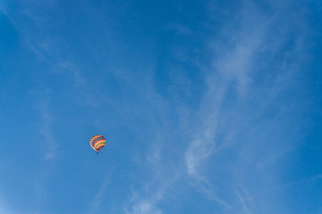Colorful hot air balloon on bright blue sky