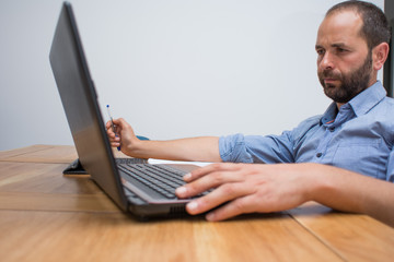 man working at home with laptop