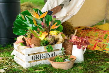 wooden box with flowers in grass, countryside