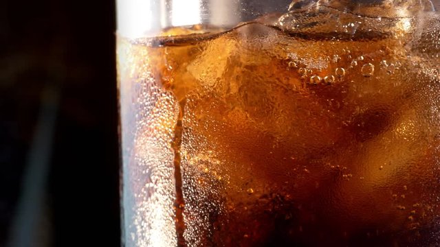 Video of cold cola with ice cubes in 4K