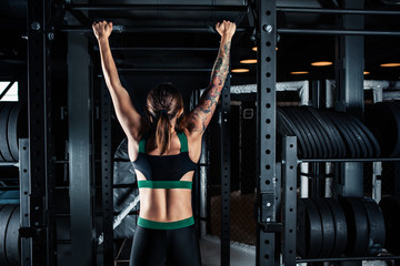 Fototapeta na wymiar Sporty woman doing lifting up