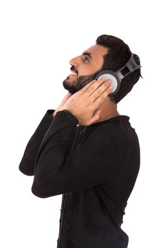 Handsome happy beard young man with headphones smiling and listening to music, guy wearing black t-shirt, isolated on white background