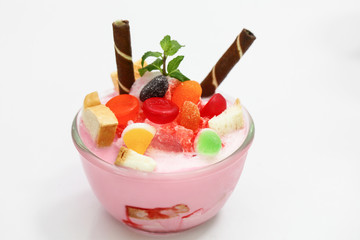 Pink milk smoothie in cup have topping is jelly bread and biscuit