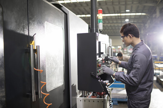 Confident engineer working in the factory