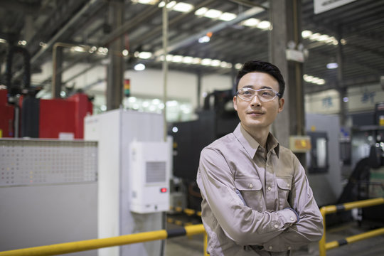 Confident engineer in the factory