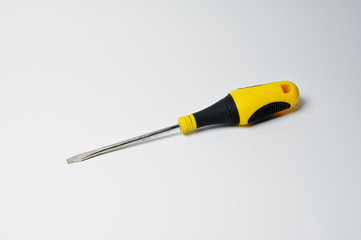 Close-up photo of black and yellow screwdriver on the white background.