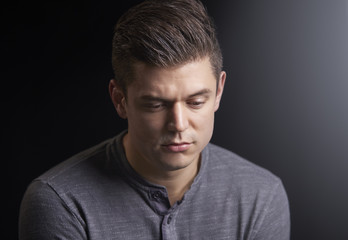 Obraz premium Portrait of a worried young man looking down
