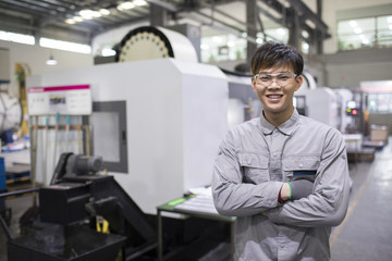 Confident engineer in the factory