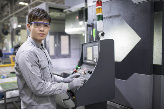 Confident engineer working in the factory