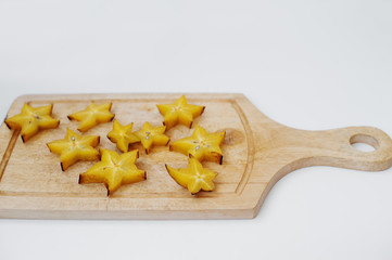 Close-up photo of star fruit or carambola slices on the table.