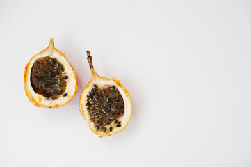 Close-up photo of two halves of passion fruit on the table.