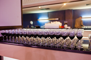 Close-up photo of a huge quantity of glasses filled with red wine.
