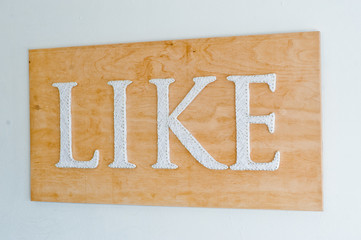 Close-up photo of an inscription written with white letters saying "like".