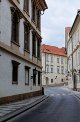 Fototapeta na wymiar Czech Republic, Prague. Street between old tenements houses with red tiles.
